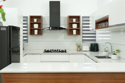A modern kitchen featuring a sleek chimney and hob setup with polished countertops.