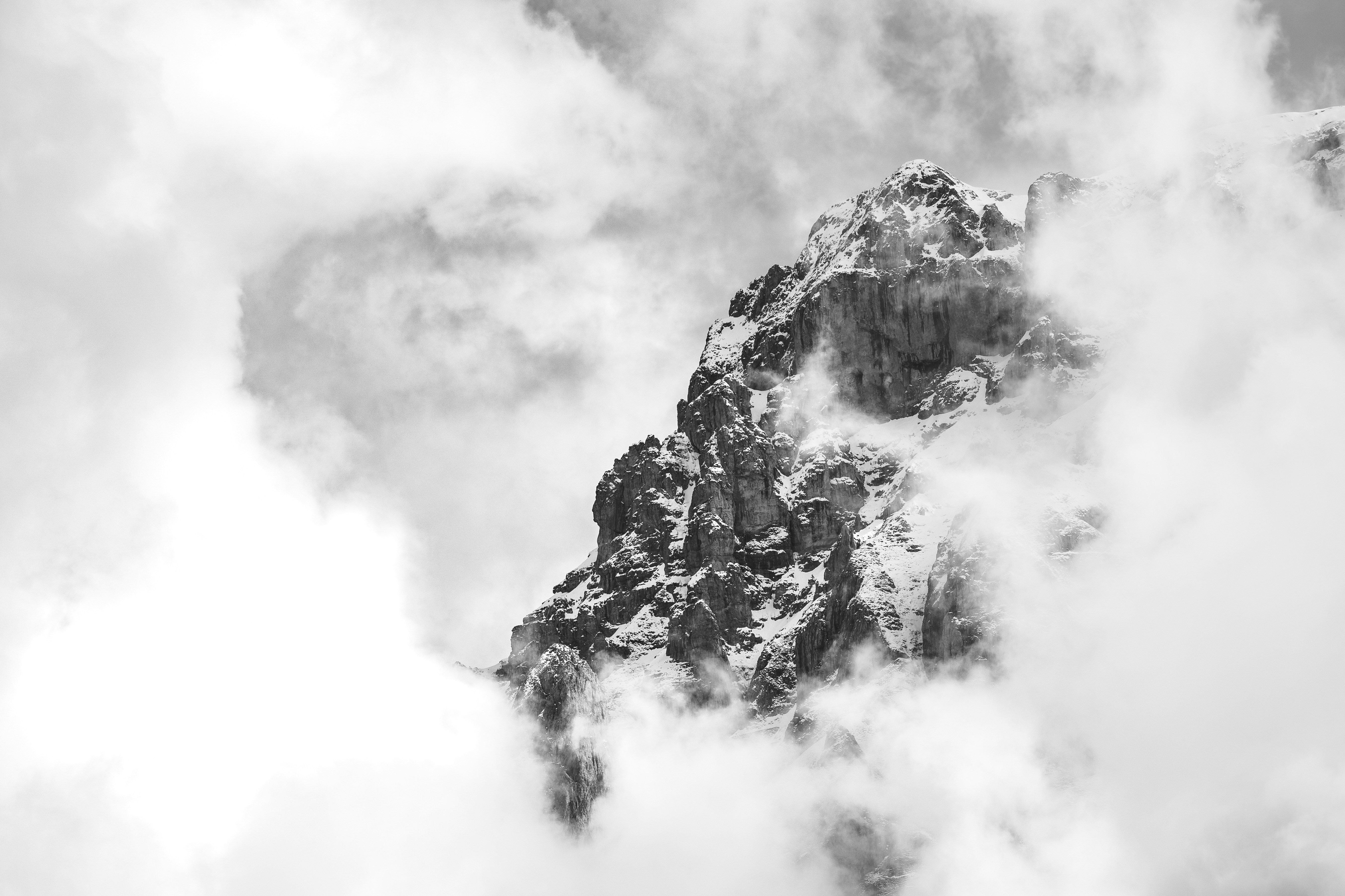 a black and white photo of a mountain in the clouds, "Hidden"