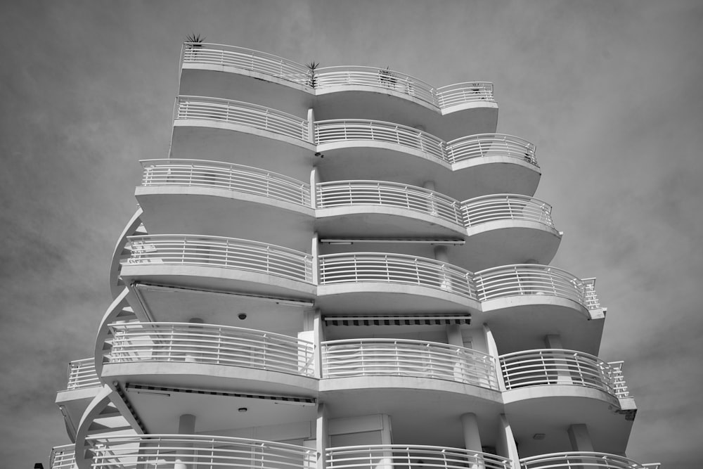 a tall white building with balconies and balconies