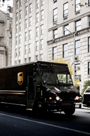 a ups truck driving down a city street