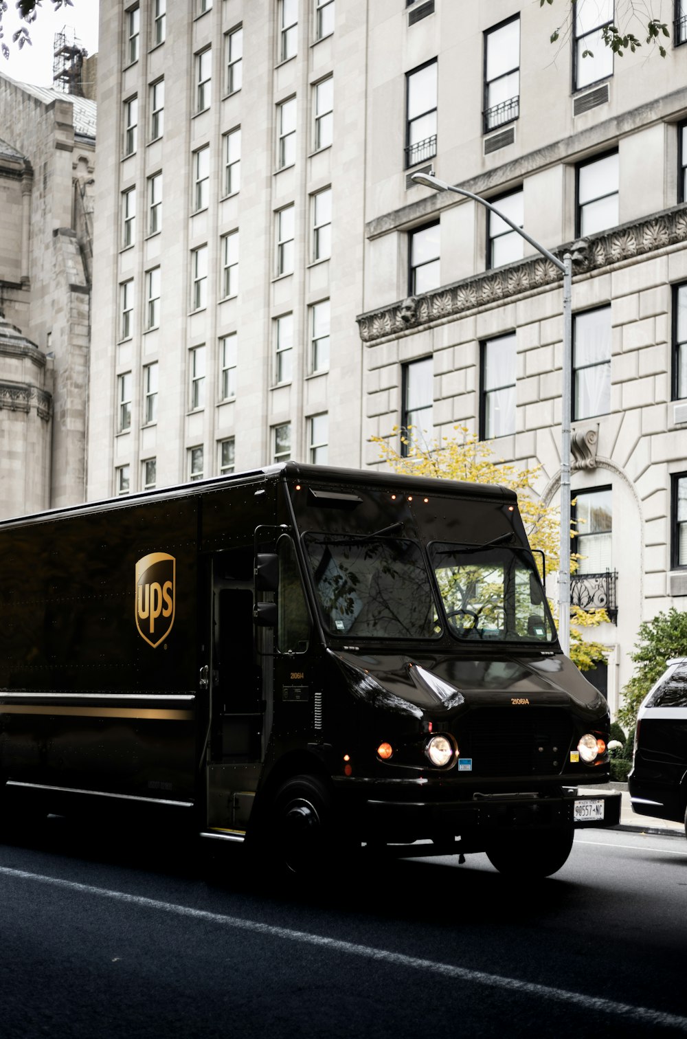 a ups truck driving down a city street