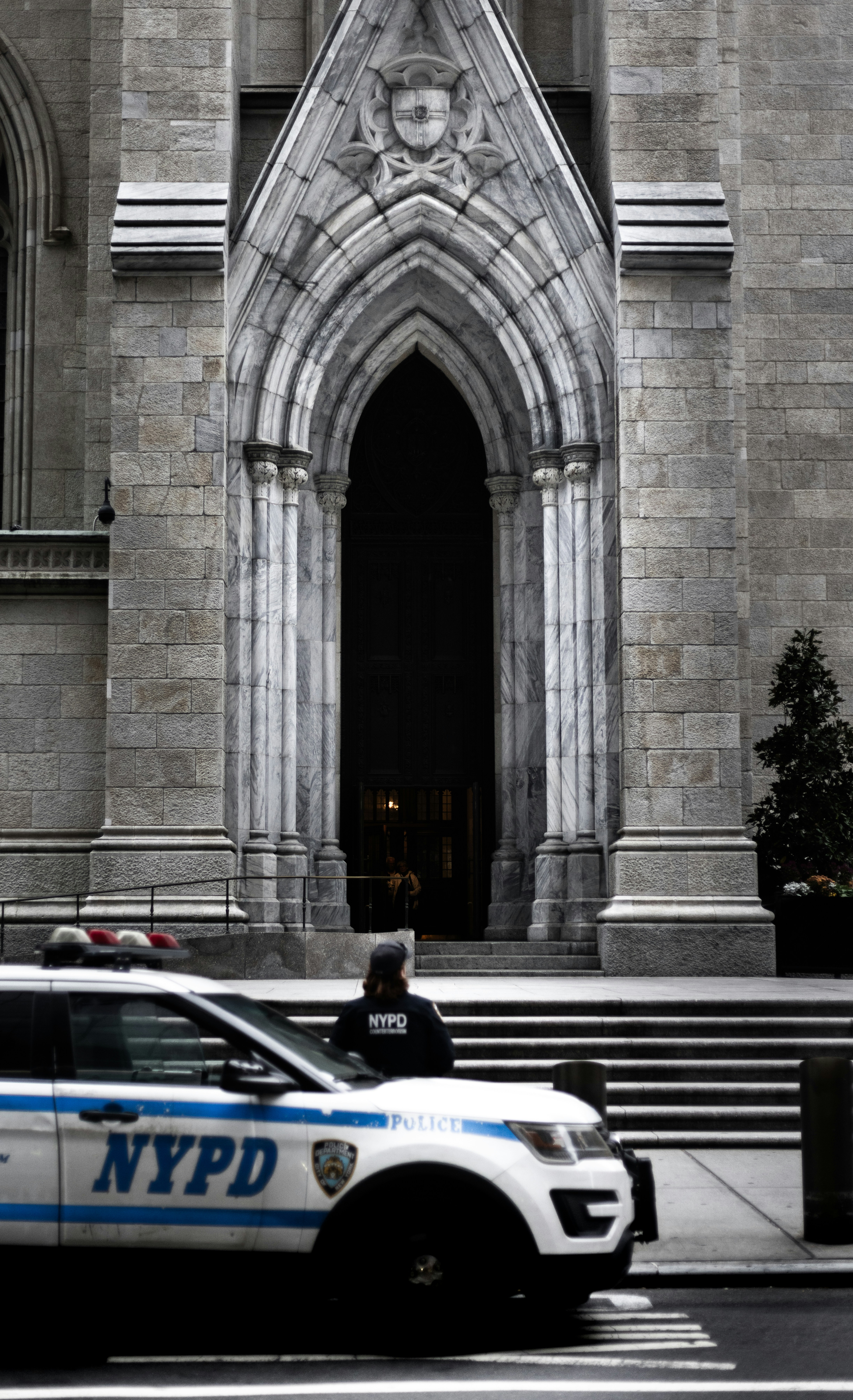 a police car parked in front of a large building