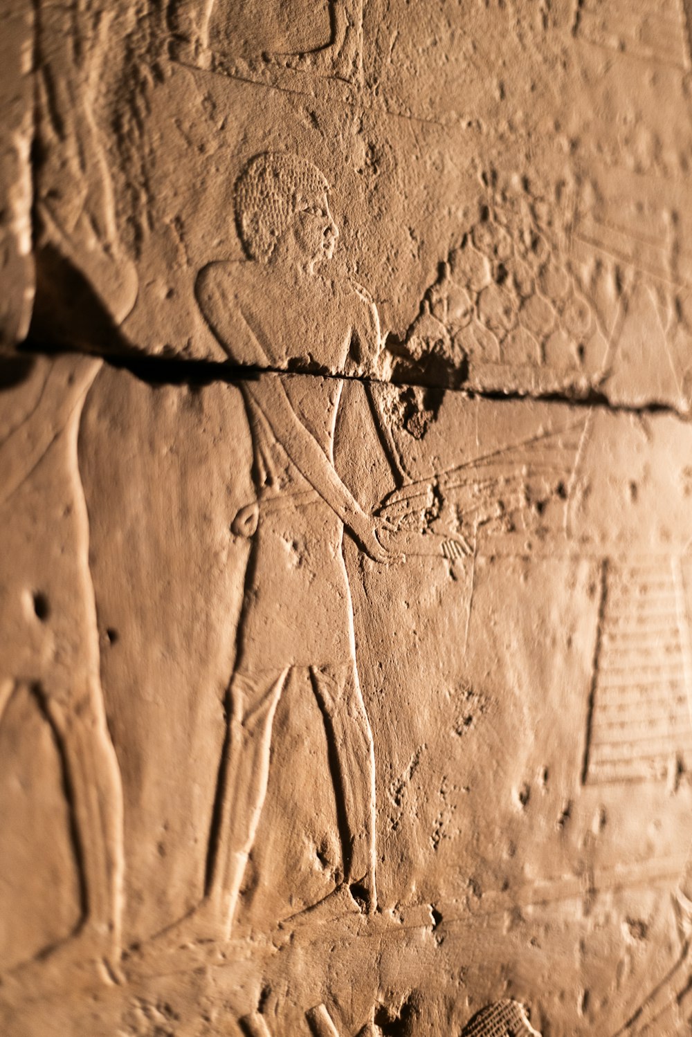 a close up of a stone wall with carvings on it