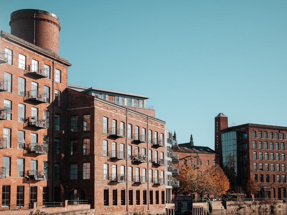 a large brick building sitting next to a body of water