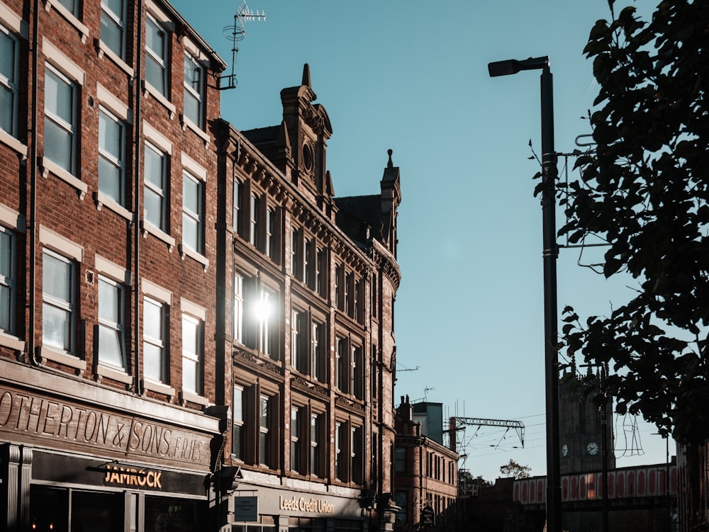 a tall brick building sitting next to a traffic light