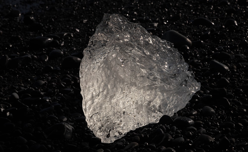 a large rock sitting on top of a black ground