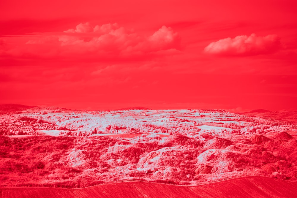 a red and white photo of a landscape