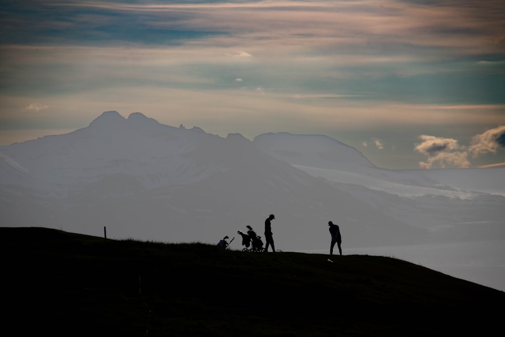 a group of people standing on top of a hill