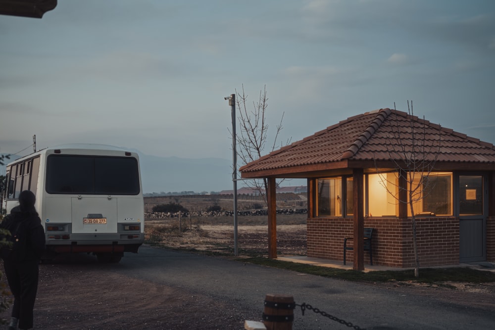 a bus parked in front of a small building