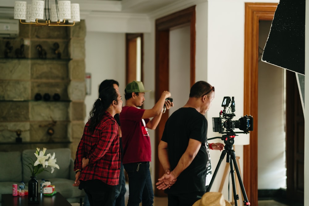 a group of people standing around a living room