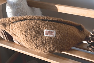 Close-up of a cozy meditation eye mask and a small seed pouch on a soft fabric background.