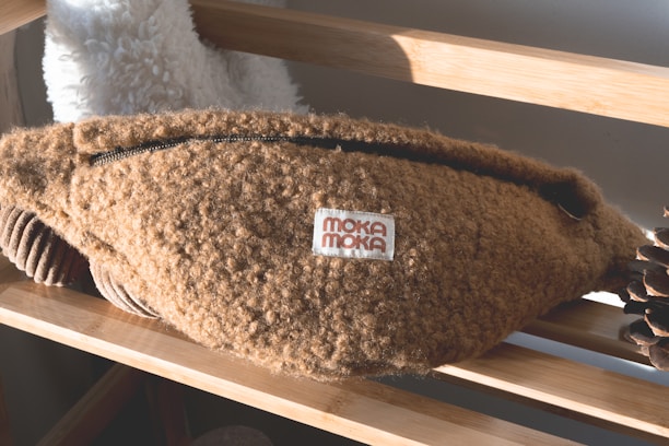 Close-up of a cozy meditation eye mask and a small seed pouch on a soft fabric background.