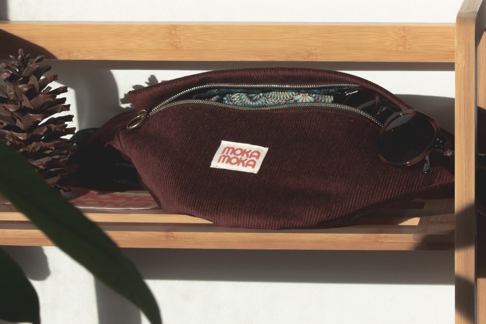 a brown bag sitting on top of a wooden shelf