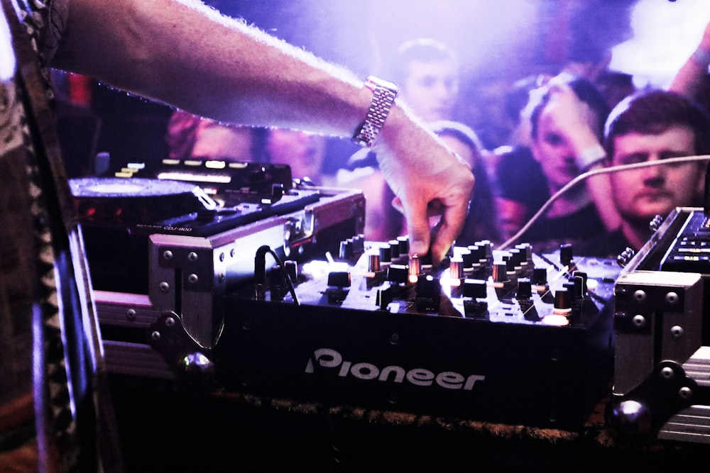 a dj mixing music in front of a crowd