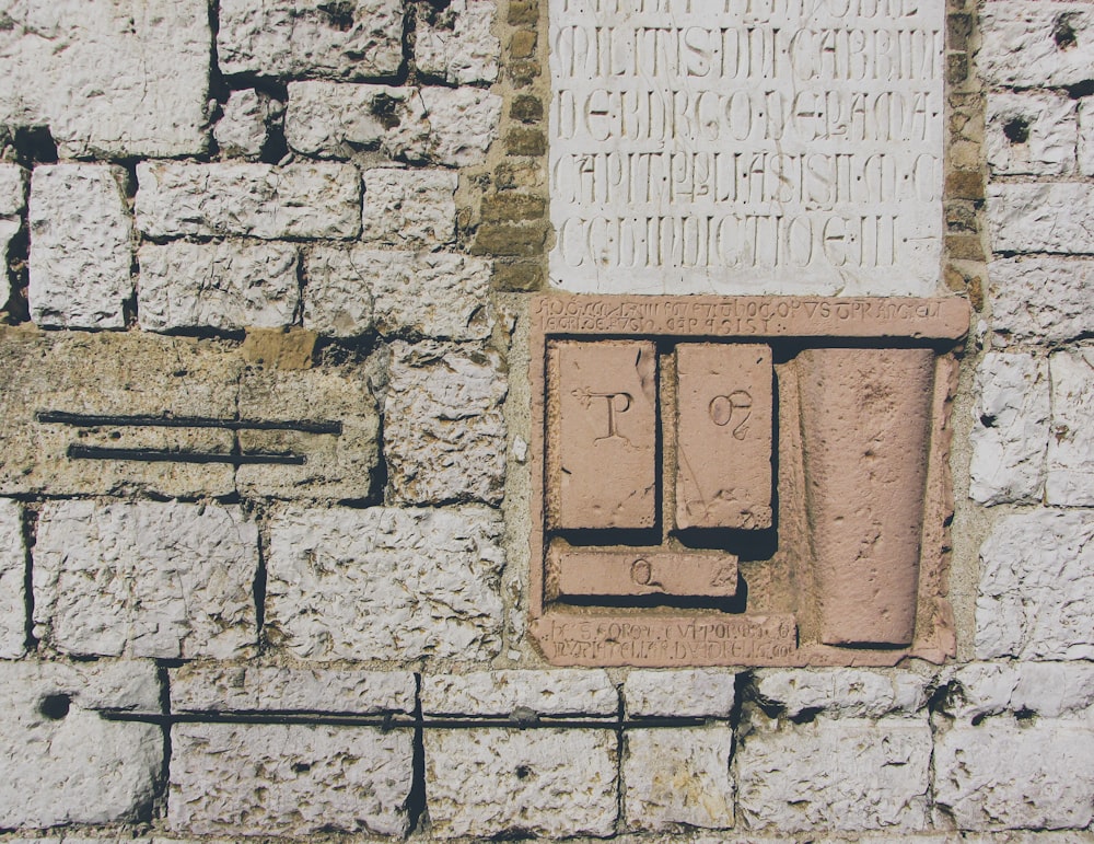 a close up of a brick wall with writing on it