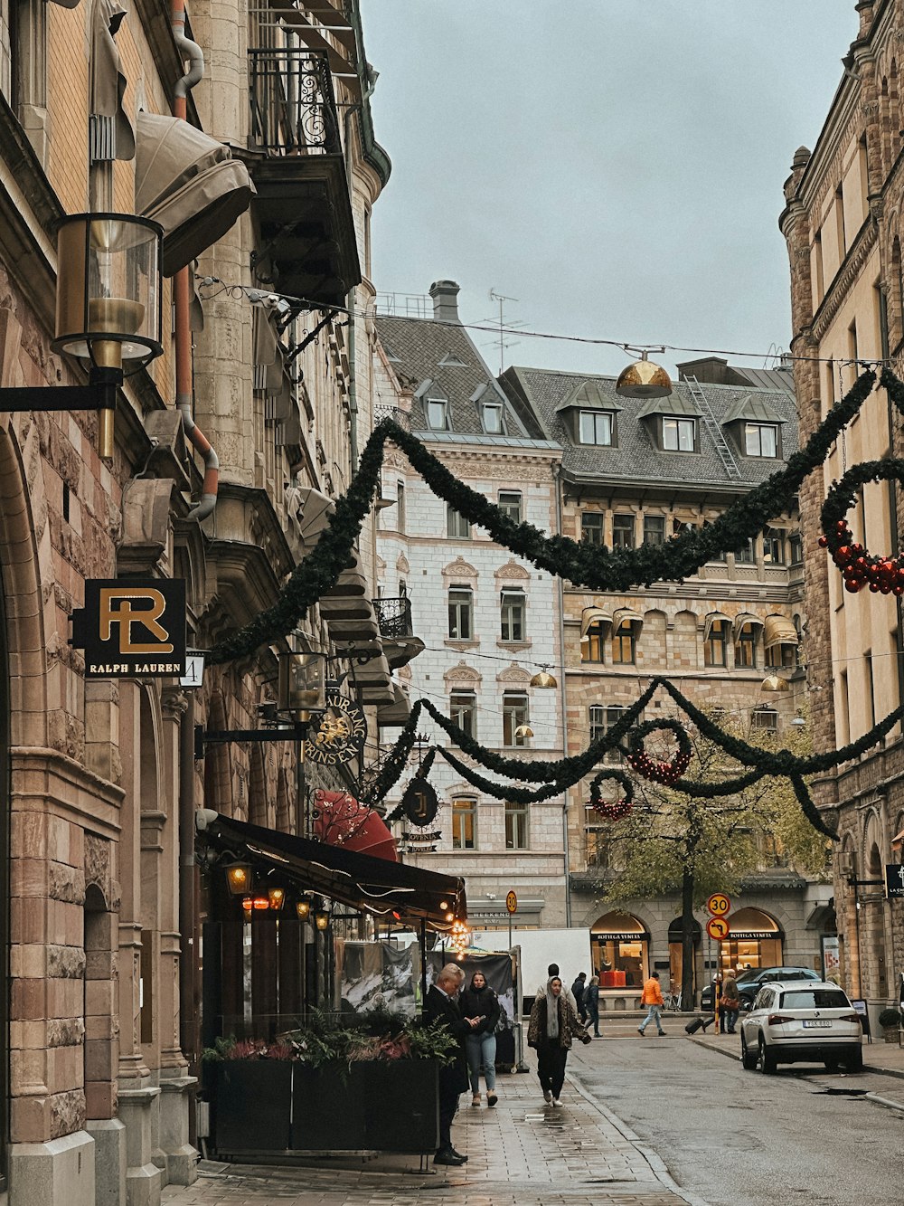 a city street is decorated with christmas lights