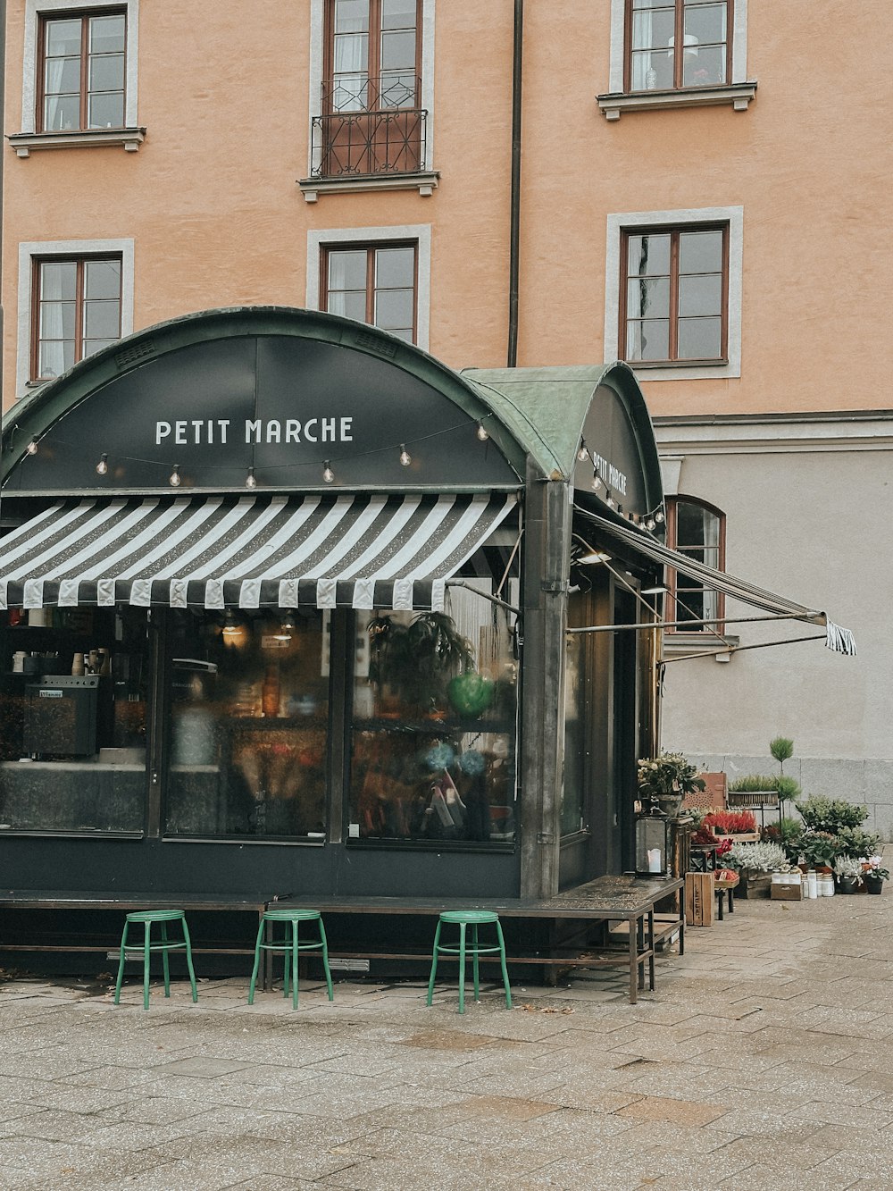 a small restaurant with a striped awning