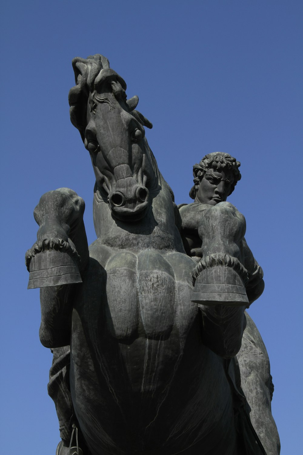 a statue of a horse with a woman on its back