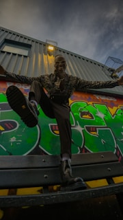 A dynamic shot of a model in Costa Mesa, showcasing urban street style against colorful murals.