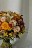 An elegant graduation bouquet featuring vibrant flowers in warm tones.
