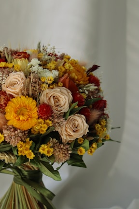 An elegant graduation bouquet featuring vibrant flowers in warm tones.