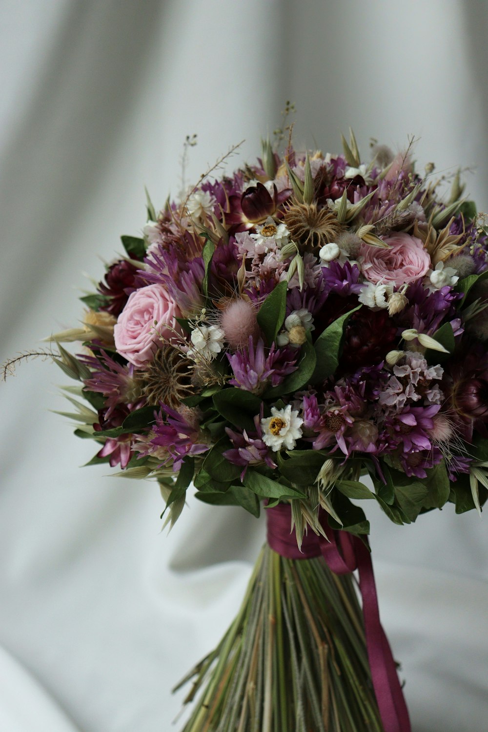 a bouquet of flowers on a white cloth