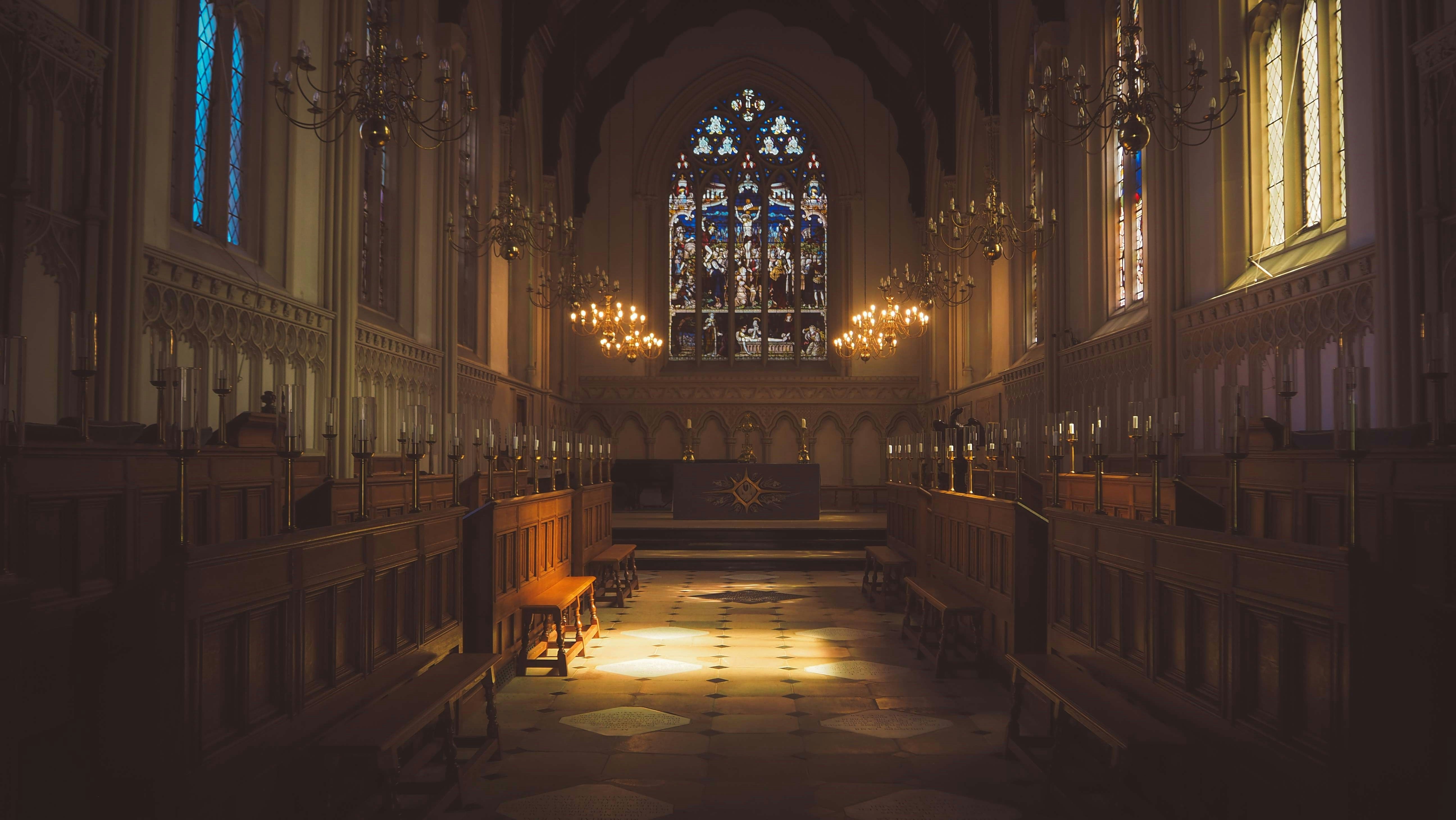 a church with stained glass windows and pews