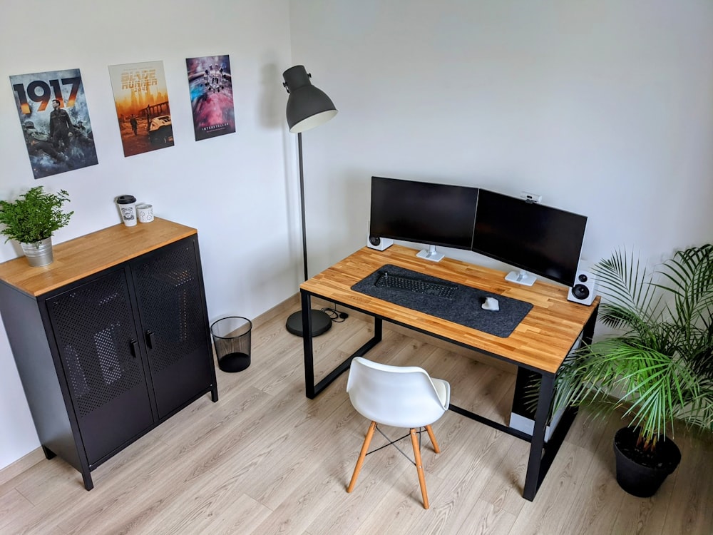 a desk with a computer on top of it