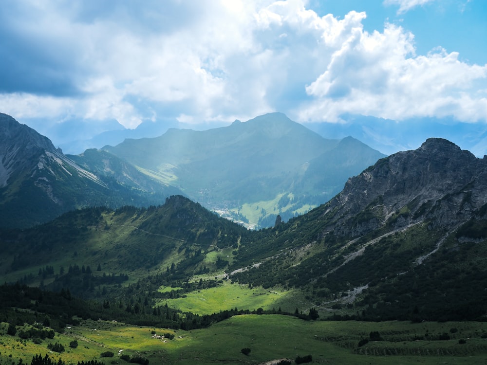 a view of a valley with mountains in the background