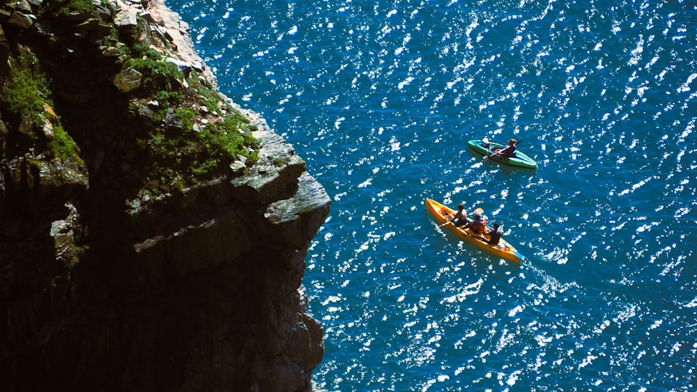 a couple of people in a kayak on a body of water