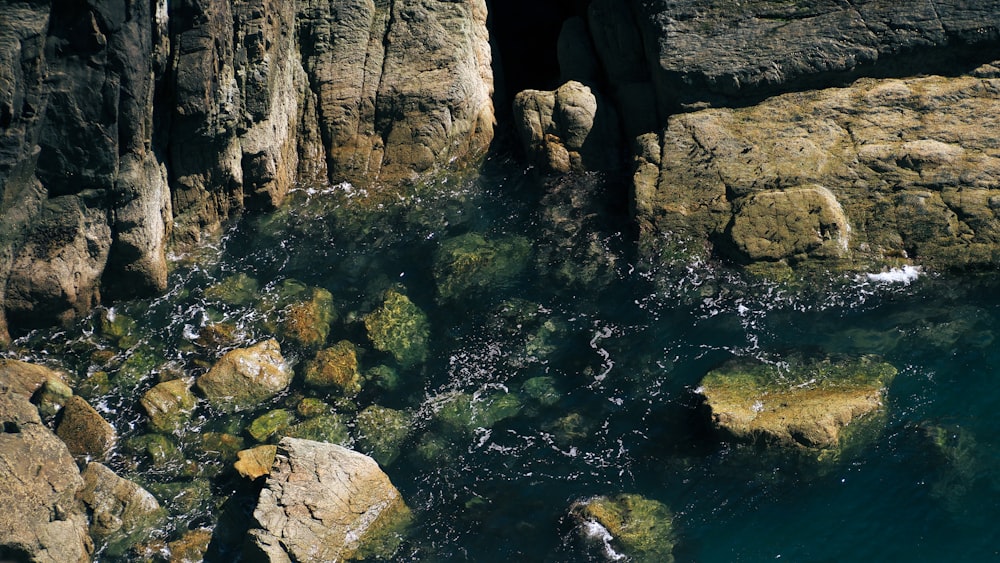 a body of water surrounded by large rocks