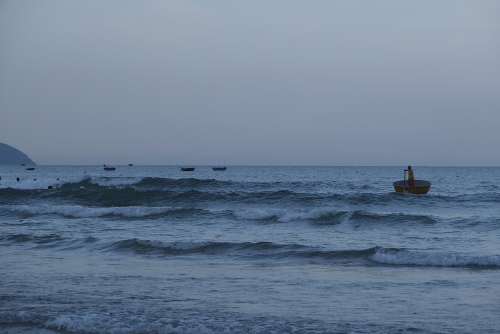 a small boat in the middle of a large body of water