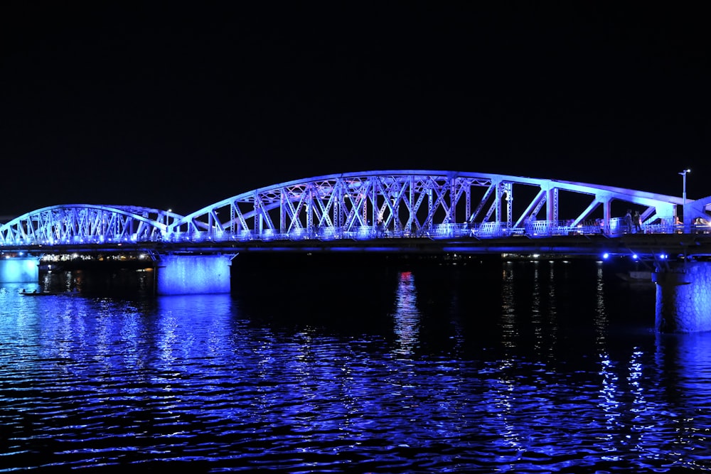 a large bridge over a body of water at night