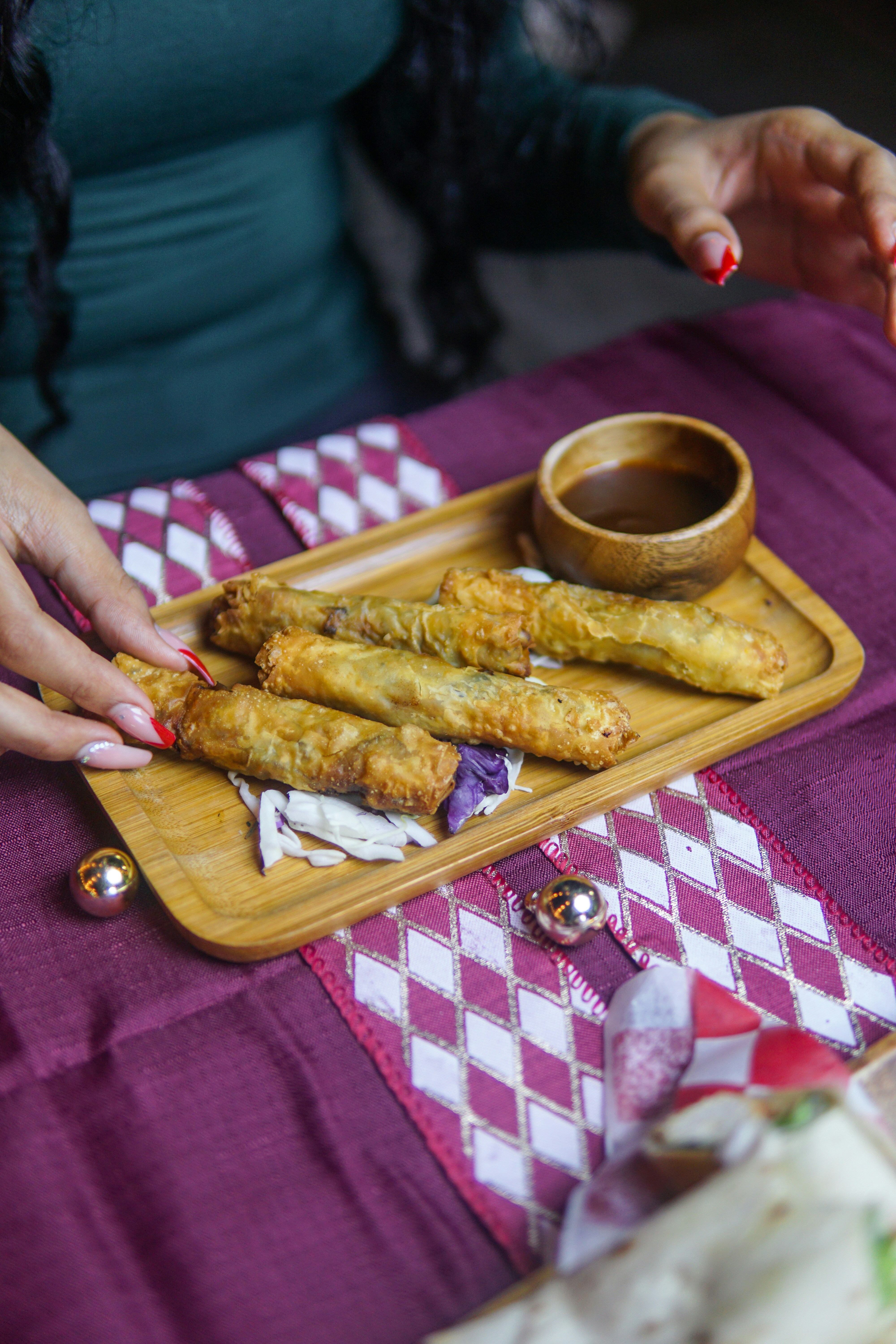 a person sitting at a table with a plate of food