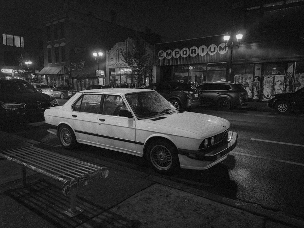 a white car parked on the side of a street