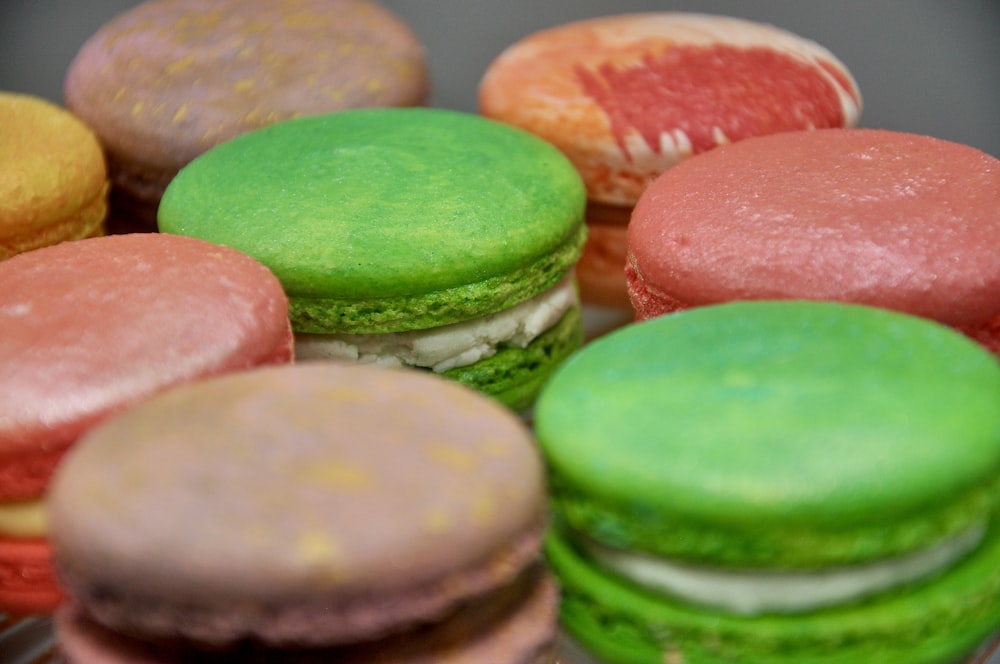 a close up of many different colored macaroons