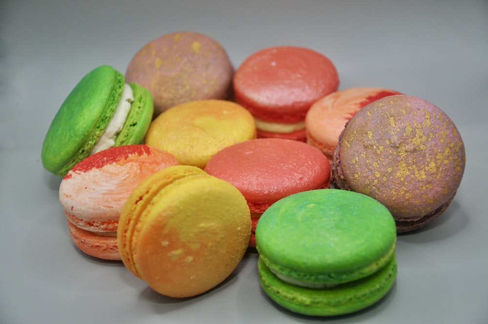 a pile of colorful macaroons sitting on top of a table