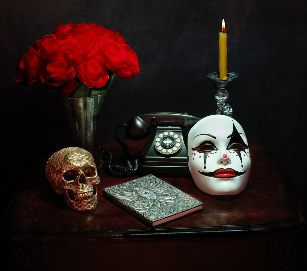 a table topped with a skull and a phone