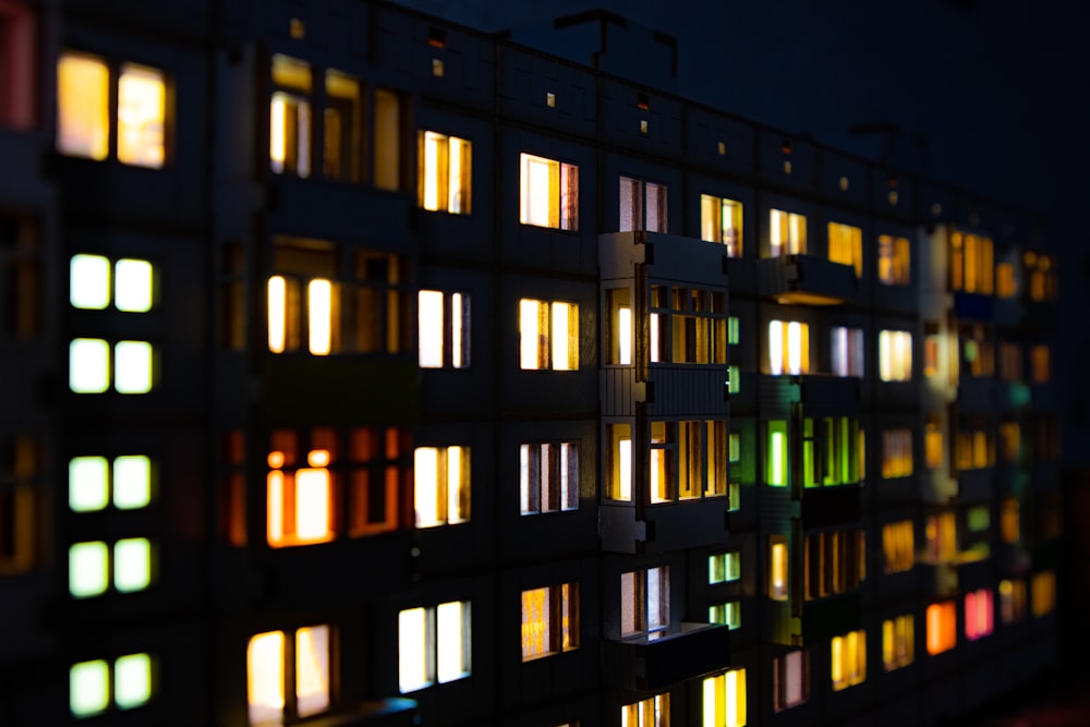 a building that has many windows lit up at night