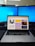 A professional workspace with a laptop and automation tools displayed on the screen.