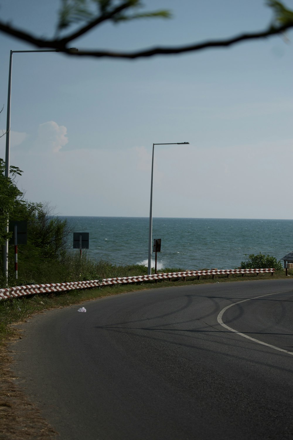 a curve in the road near the ocean