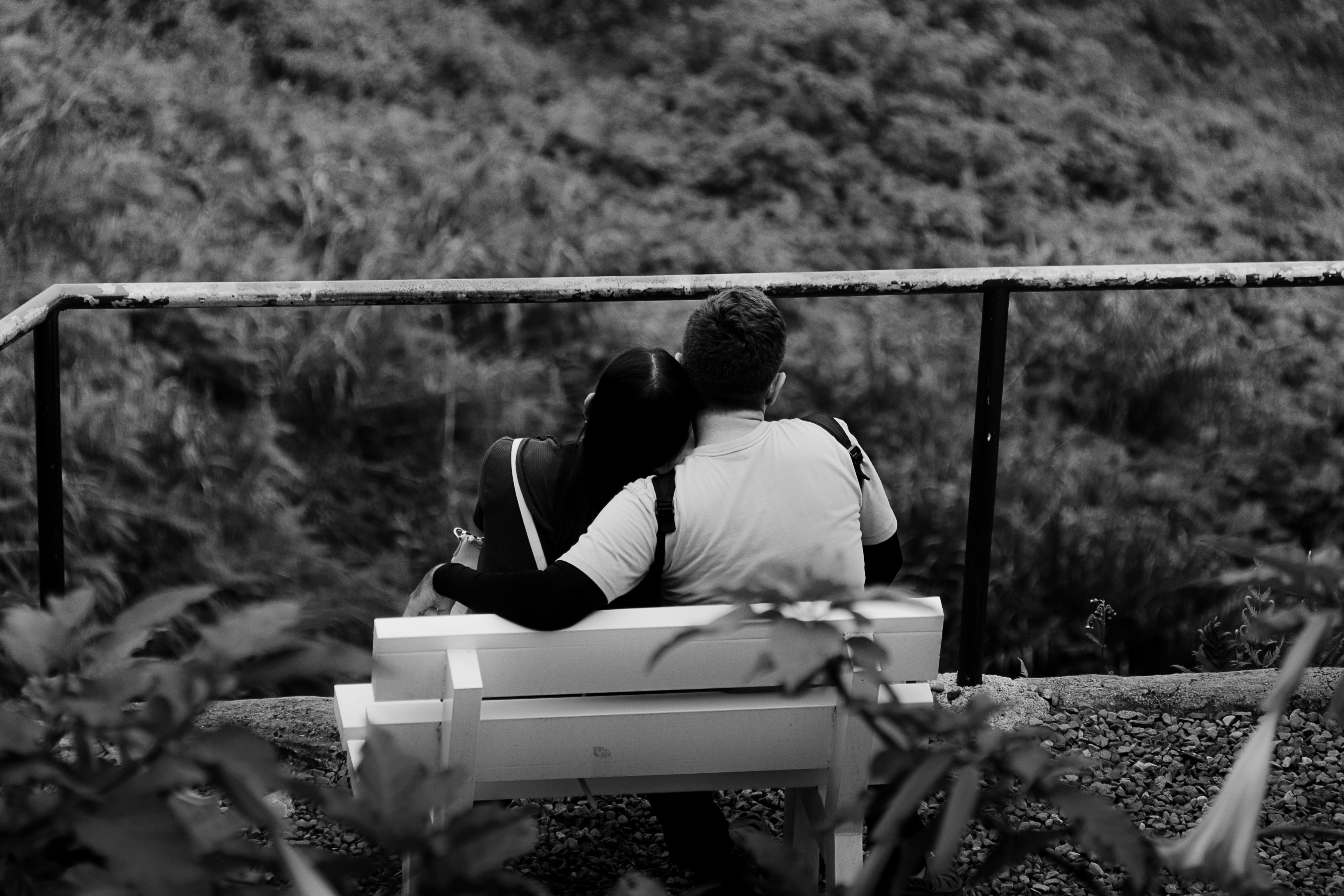 a man and a woman sitting on a bench