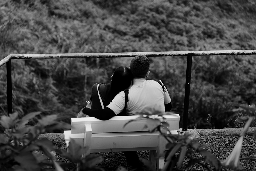 a man and a woman sitting on a bench,