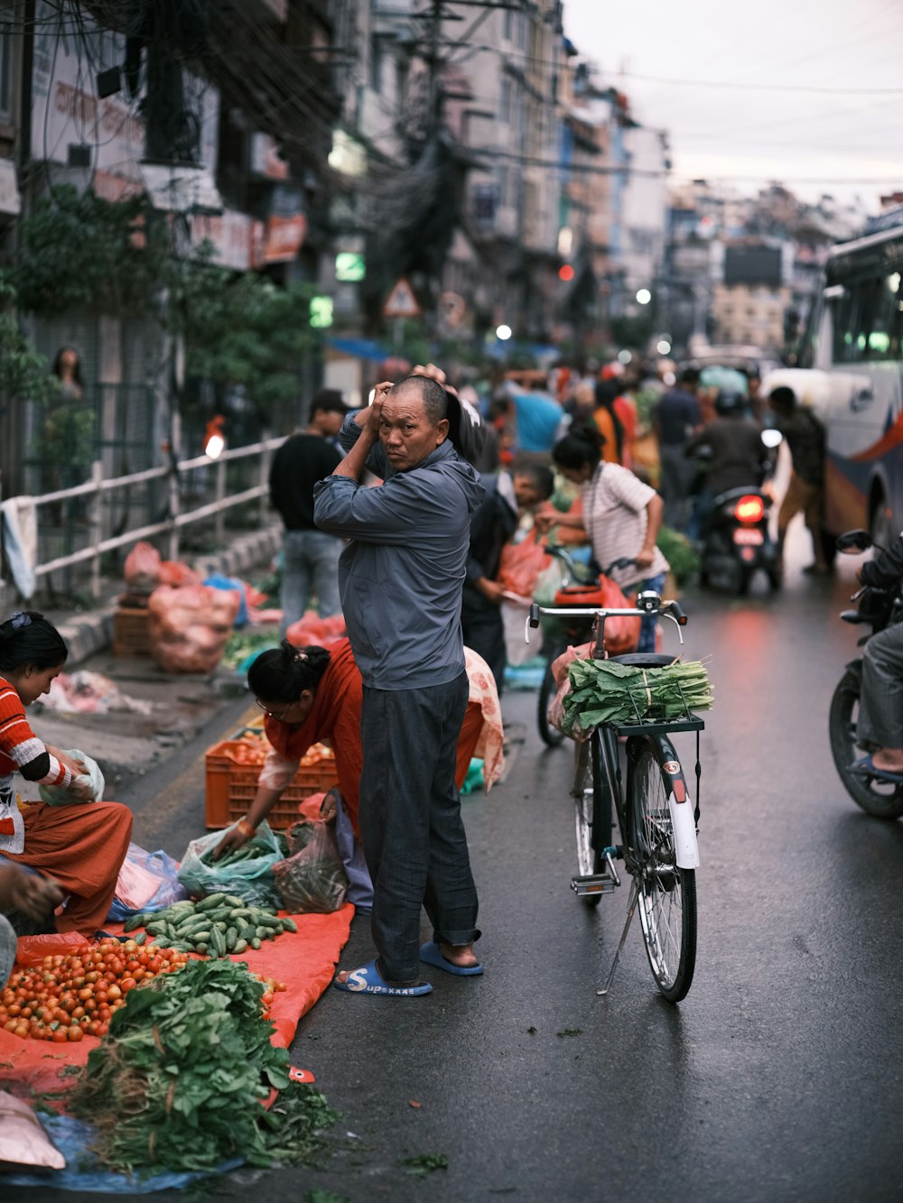 a man talking on a cell phone while standing in the middle of a street