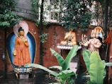 A peaceful courtyard with greenery and religious statues.