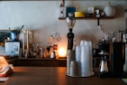 A cozy corner with coffee brewing equipment and a cup ready to serve