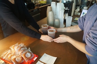 Happy customers exchanging their points for coffee mugs and pastries.