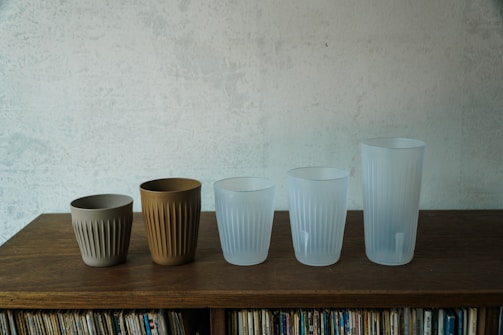 Close-up of colorful silicone cups used in ventosa therapy arranged neatly on a wooden table.