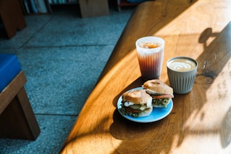 A cozy wooden table with a variety of homemade sandwiches and fresh ingredients.
