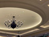 Ceiling with intricate plaster molding and soft ambient lighting.